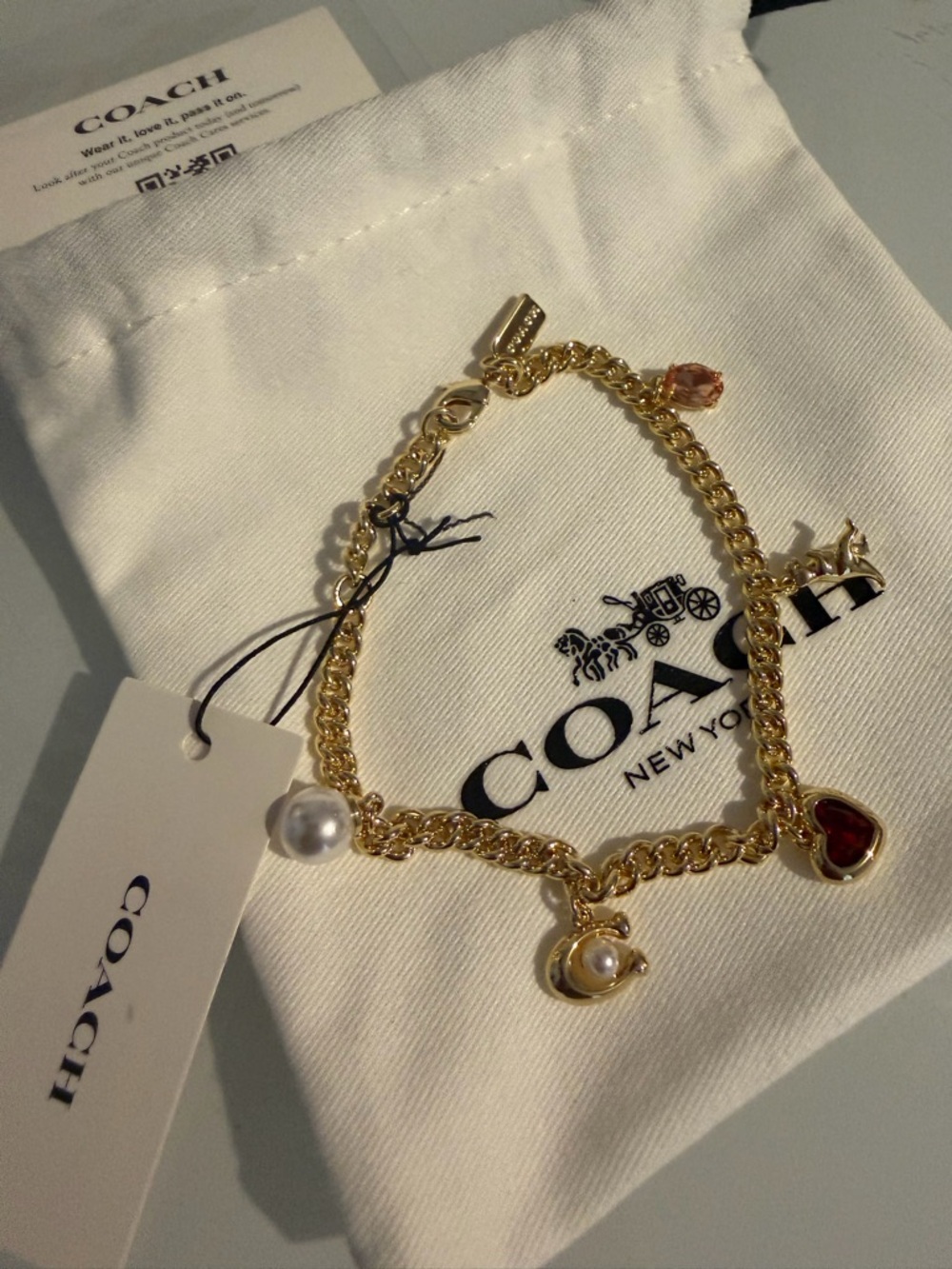 Coach Gold multi Charm Bracelet with Red Heart and Pearl Charms